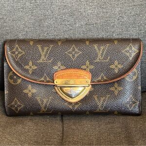 Authentic Louis Vuitton monogram international wallet with front buckle and lock